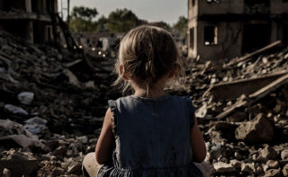 Small,children,on,a,pile,of,building,rubble